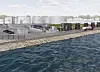 Kustnära industriplats med lagringstankar, rörkonstruktioner och fordon vid vattnet.
